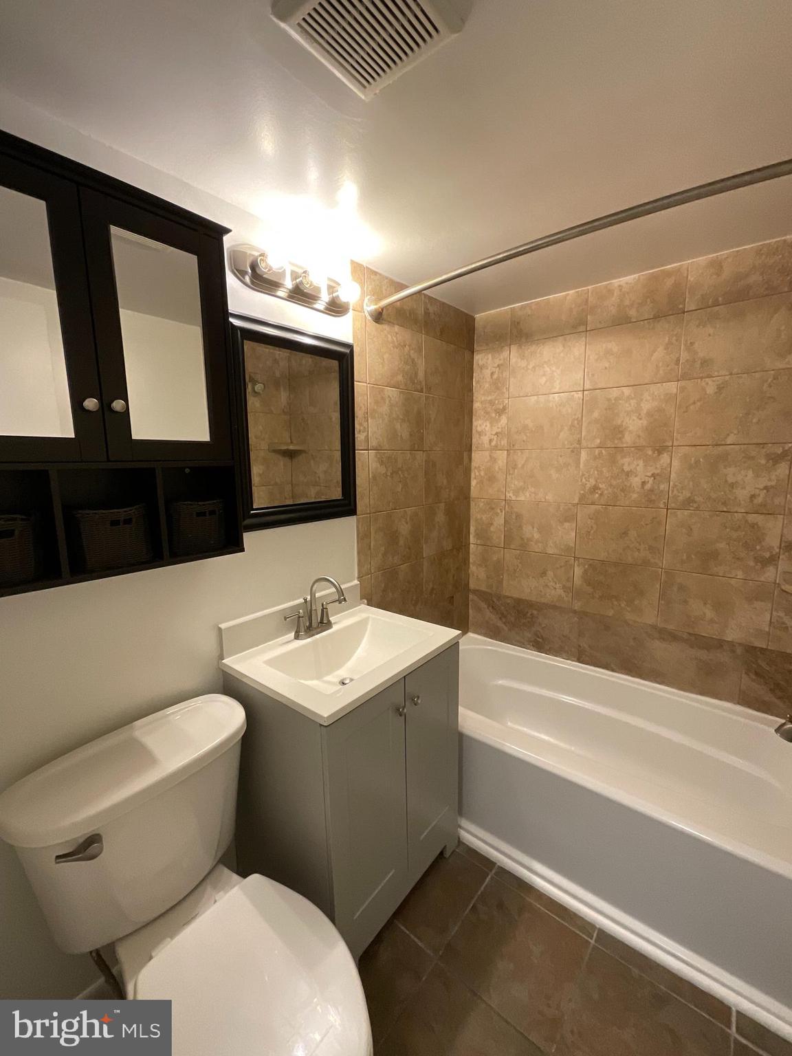 4509 Romlon Street, Unit 102 Beltsville, MD 20705 - Photo 10 of 22 a bathroom with a toilet a sink and a mirror