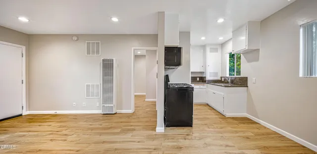 a kitchen with stainless steel appliances granite countertop a refrigerator a sink and a stove