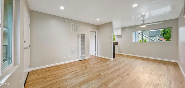 a view of empty room with wooden floor