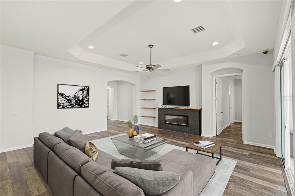 11202 Roz Way Oxford, FL 34484 - Photo 11 of 44 a living room with furniture and a flat screen tv