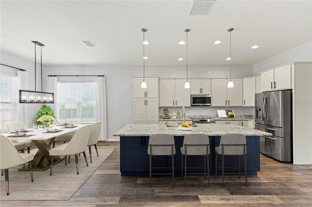 11202 Roz Way Oxford, FL 34484 - Photo 12 of 44 a large kitchen with a table and chairs