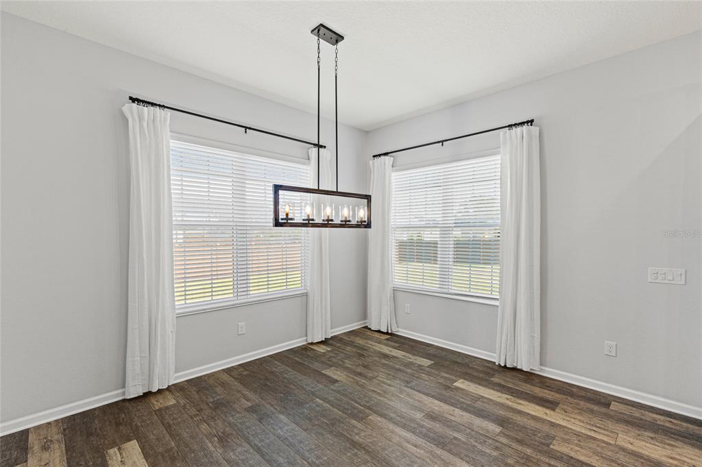 11202 Roz Way Oxford, FL 34484 - Photo 14 of 44 a view of empty room with wooden floor and fan