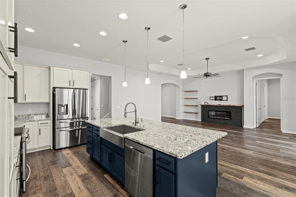 11202 Roz Way Oxford, FL 34484 - Photo 18 of 44 a kitchen with stainless steel appliances granite countertop a kitchen island a stove and a refrigerator