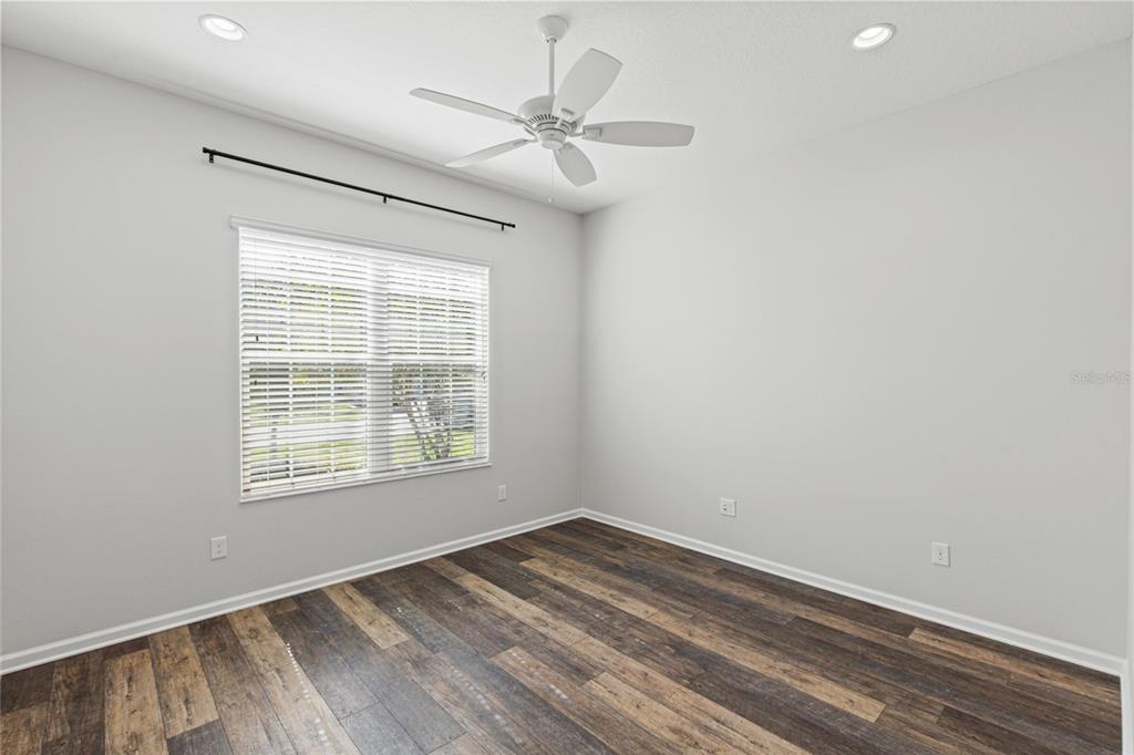 11202 Roz Way Oxford, FL 34484 - Photo 28 of 44 a view of an empty room with a window and a ceiling fan