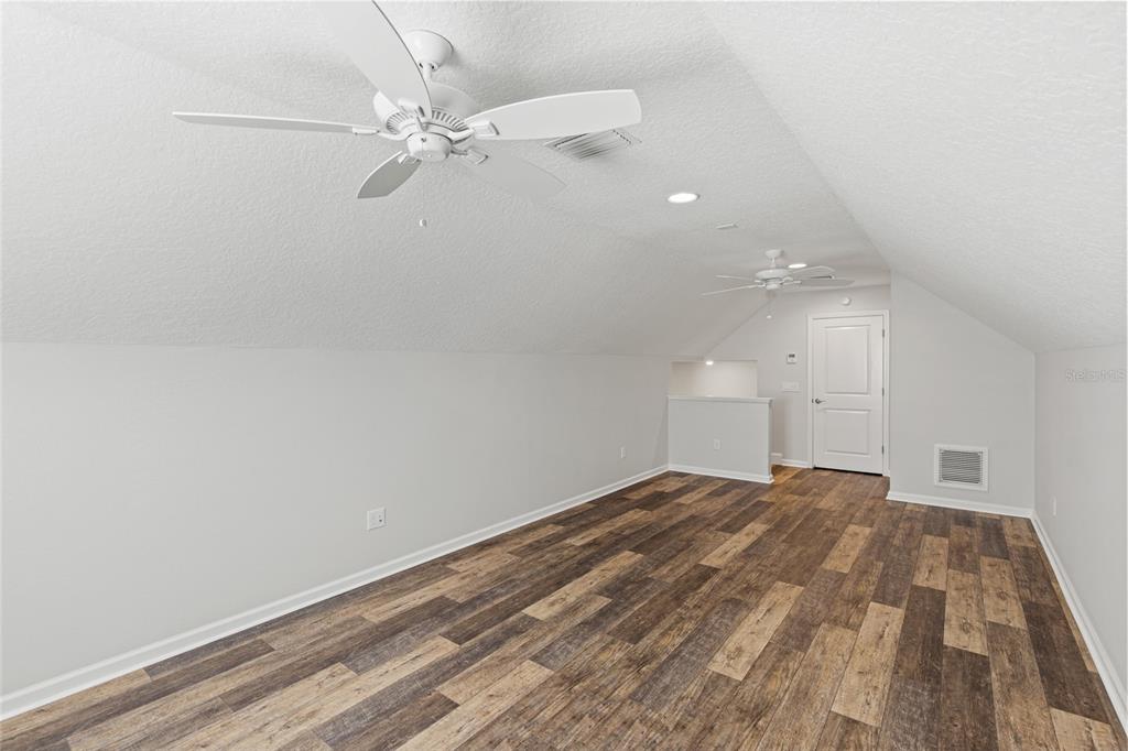 11202 Roz Way Oxford, FL 34484 - Photo 36 of 44 wooden floor in an empty room