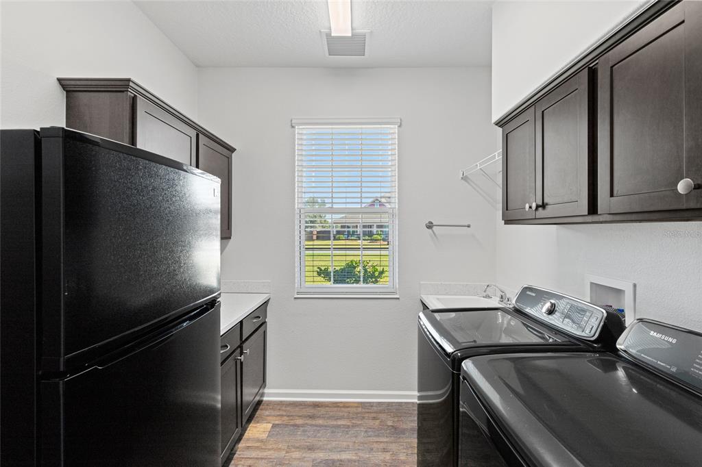11202 Roz Way Oxford, FL 34484 - Photo 37 of 44 a kitchen with a refrigerator and a stove top oven