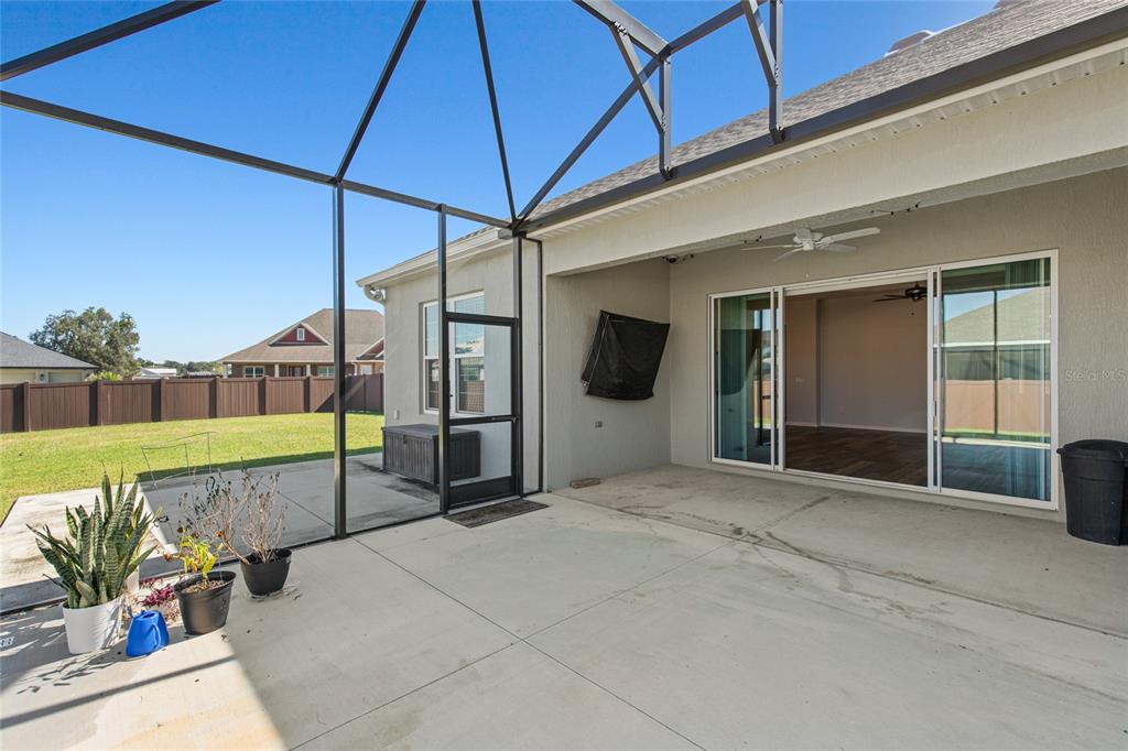 11202 Roz Way Oxford, FL 34484 - Photo 6 of 44 a view of a patio with a table and chairs under an umbrella
