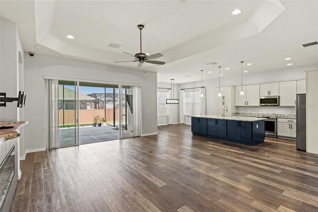 11202 Roz Way Oxford, FL 34484 - Photo 9 of 44 a large kitchen with a lot of counter space wooden floor and appliances