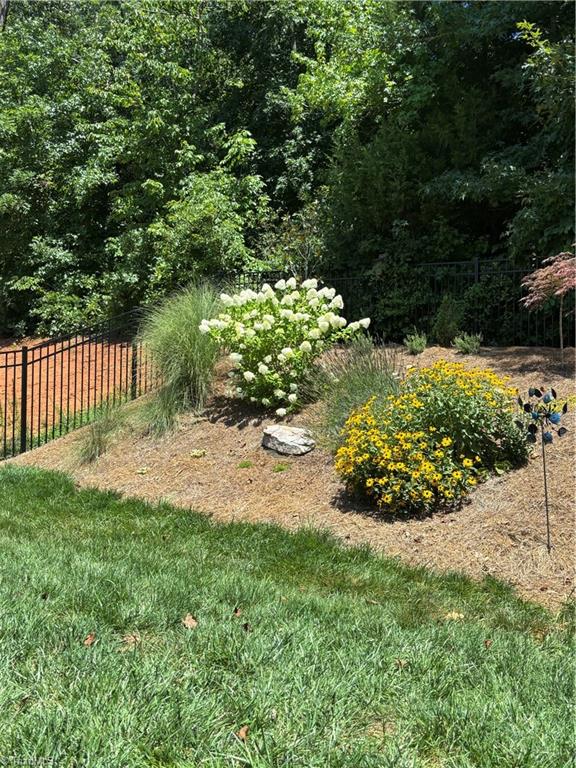 5624 Marblehead Drive Colfax, NC 27235 - Photo 32 of 36 Landscaped hill in summer