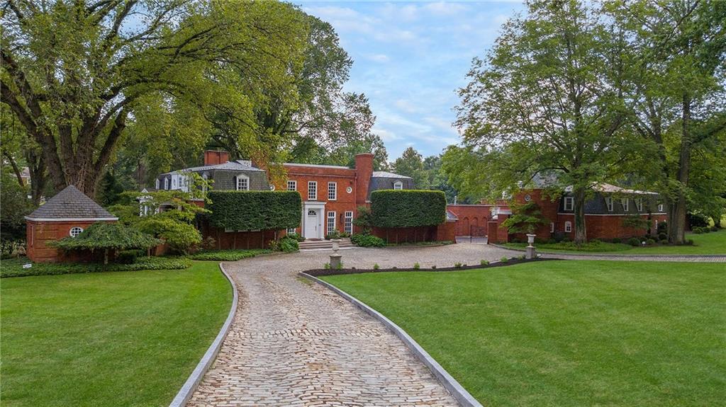 898 Persimmon Road Sewickley, PA 15143 - Photo 6 of 50 This home’s exterior is a masterclass in scale, symmetry, and setting—combining classic materials with enduring design to create a landmark estate that stands the test of time.