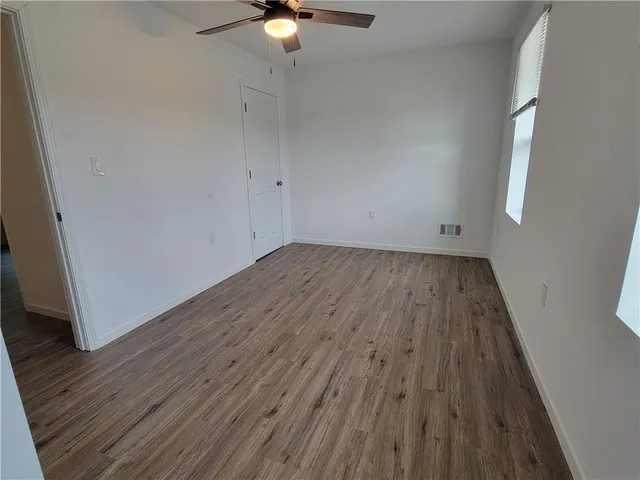 a view of a room with wooden floor