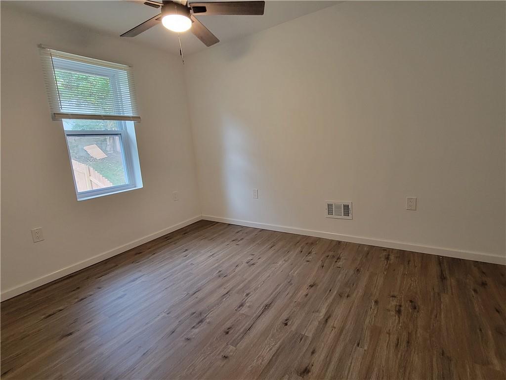 518 5th Avenue Coraopolis, PA 15108 - Photo 14 of 18 an empty room with wooden floor and windows