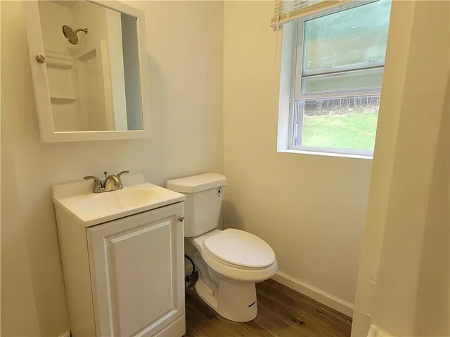 a white toilet sitting next to a bathroom sink