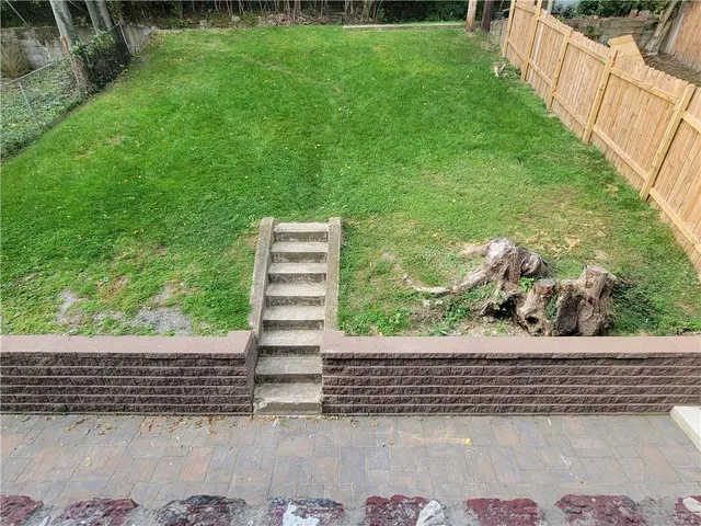 a view of a yard with potted plants