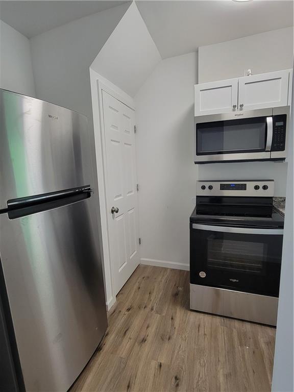 518 5th Avenue Coraopolis, PA 15108 - Photo 8 of 18 a kitchen with wooden floor and a stove top oven