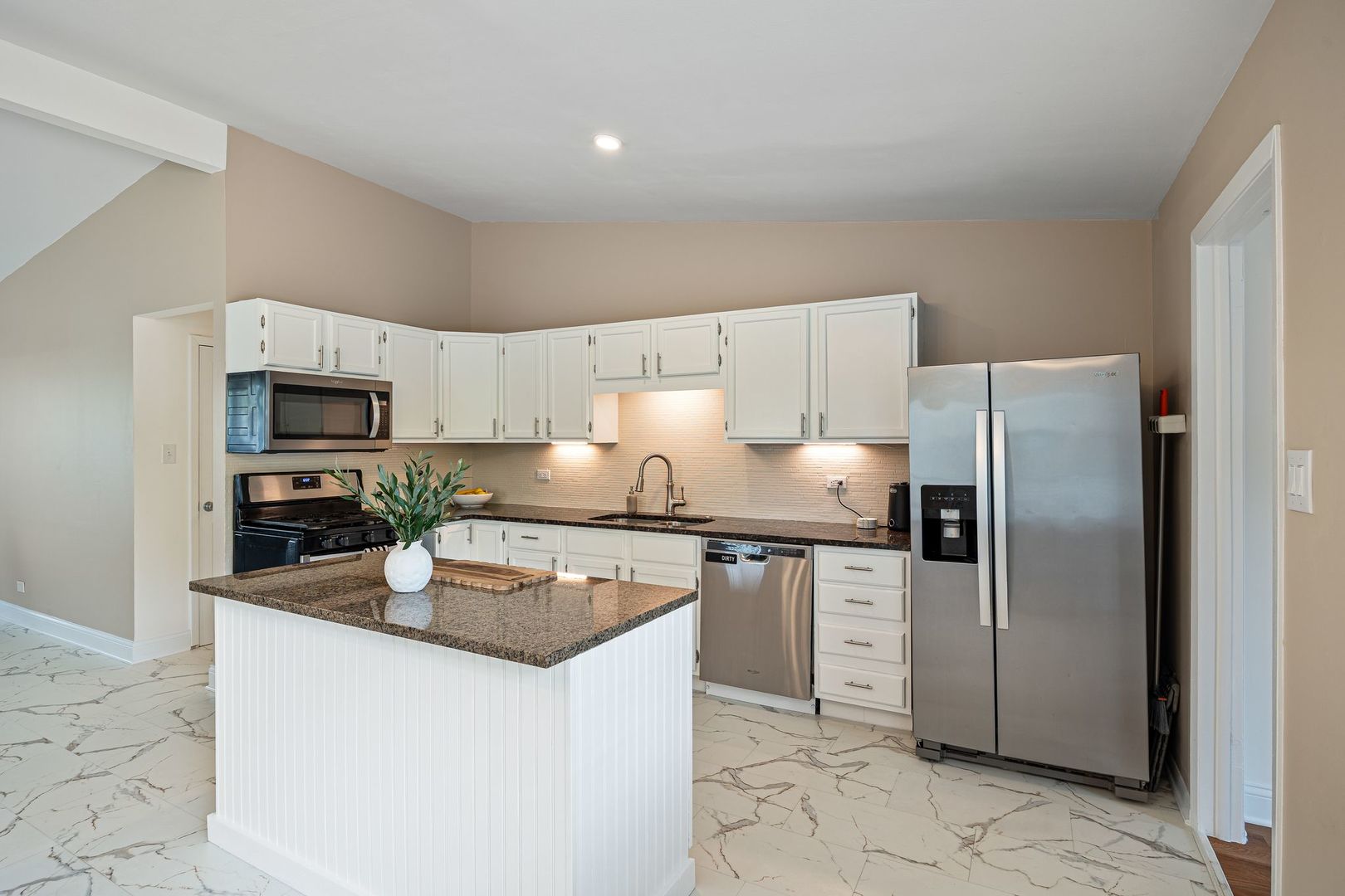 2117 Grouse Lane Rolling Meadows, IL 60008 - Photo 6 of 25 a kitchen with granite countertop a refrigerator and a stove top oven