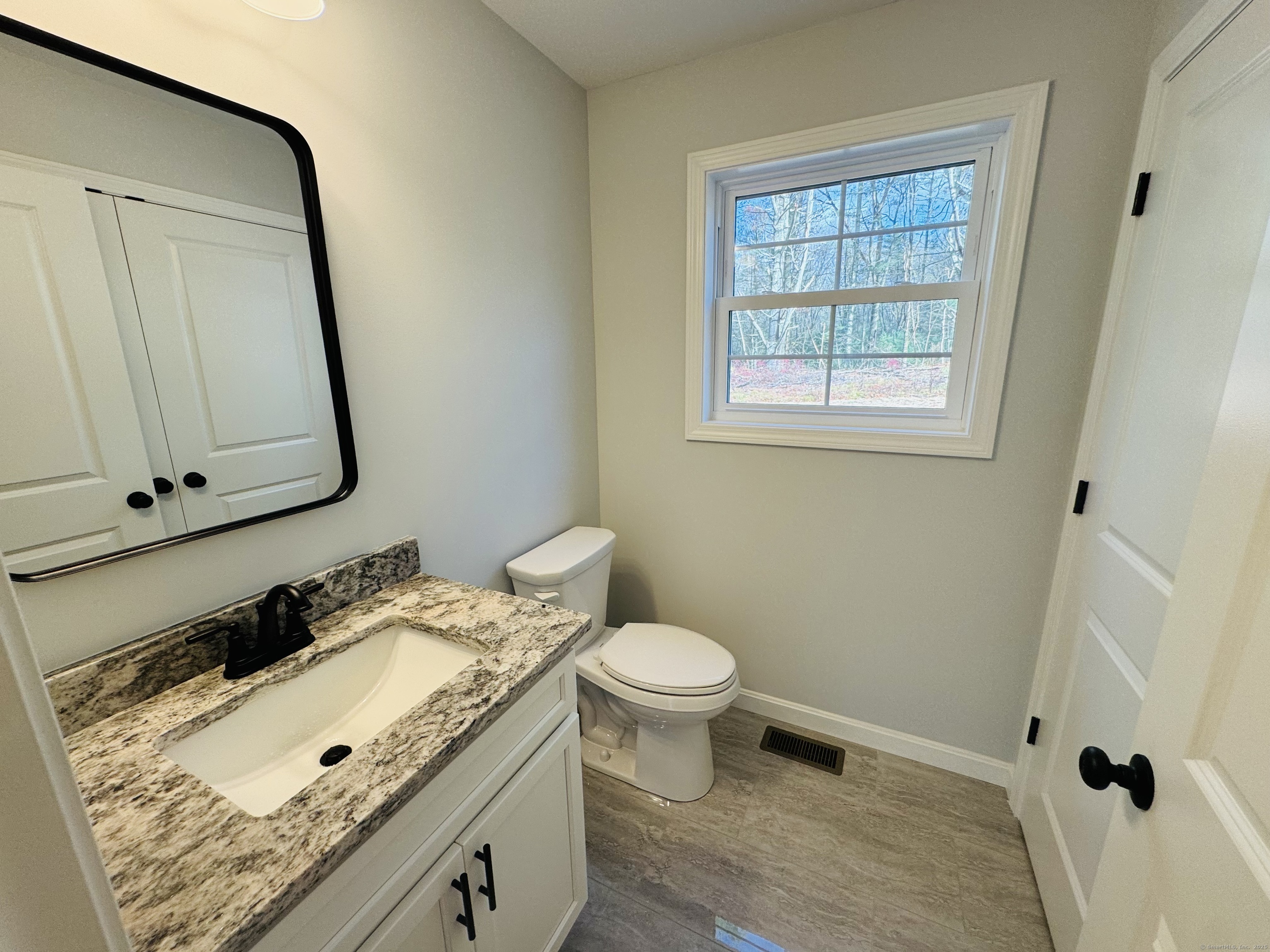 160 Ross Road Brooklyn, CT 06234 - Photo 6 of 13 a bathroom with a granite countertop sink toilet and mirror