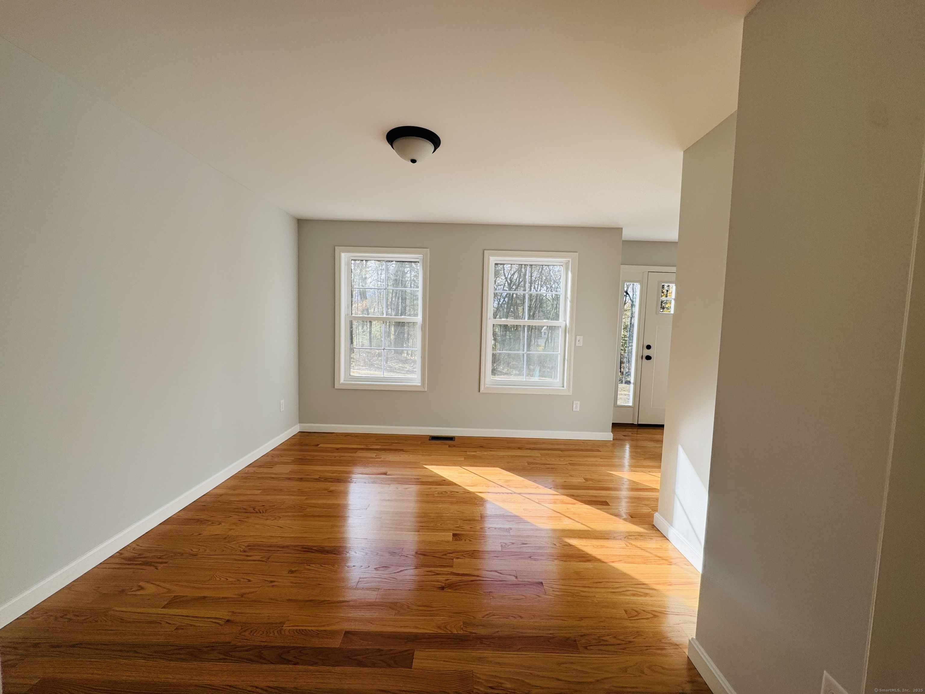 160 Ross Road Brooklyn, CT 06234 - Photo 7 of 13 a view of empty room with wooden floor and fan
