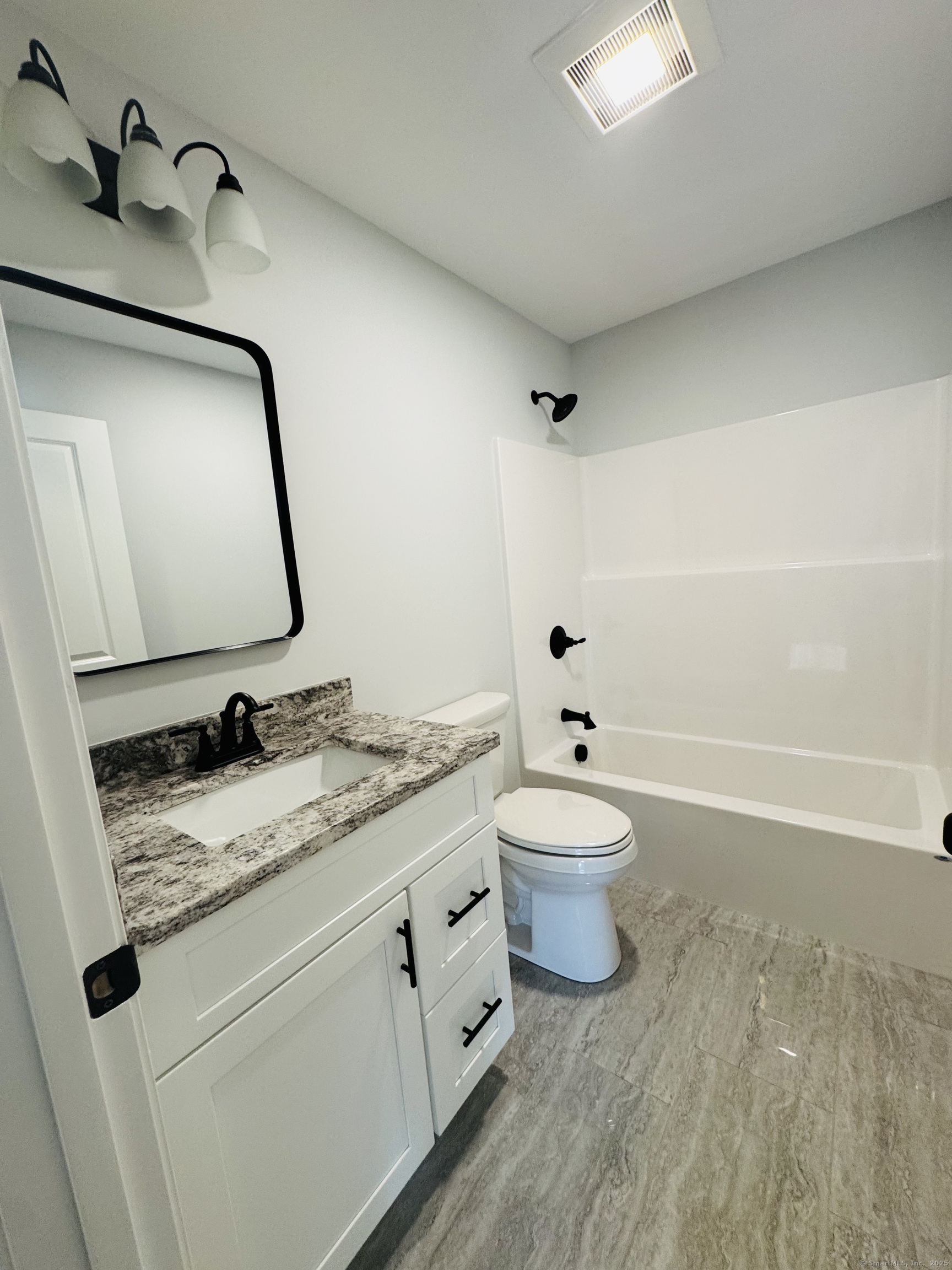 160 Ross Road Brooklyn, CT 06234 - Photo 8 of 13 a bathroom with a granite countertop toilet sink and mirror