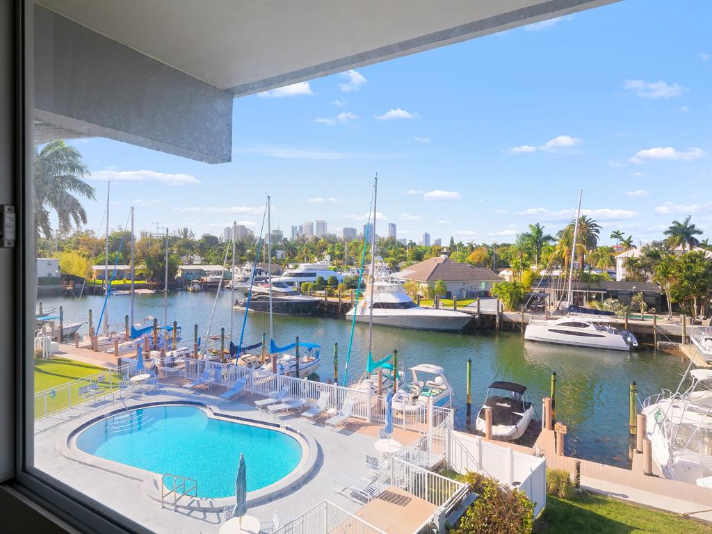 1475 Southeast 15th Street, Unit 311 Fort Lauderdale, FL 33316 - Photo 14 of 19 a view of a lake with a table and chairs