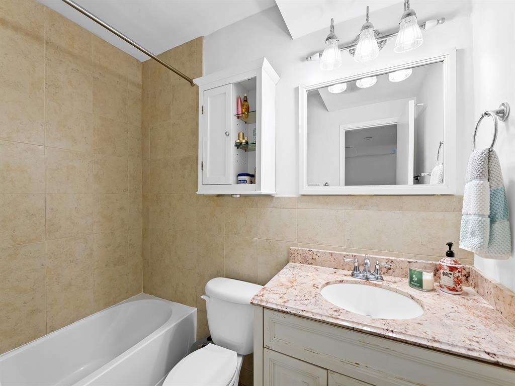 1475 Southeast 15th Street, Unit 311 Fort Lauderdale, FL 33316 - Photo 10 of 19 a bathroom with a granite countertop sink mirror and a toilet