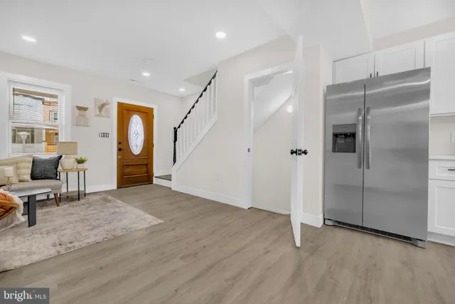 an empty room with wooden floor and a window