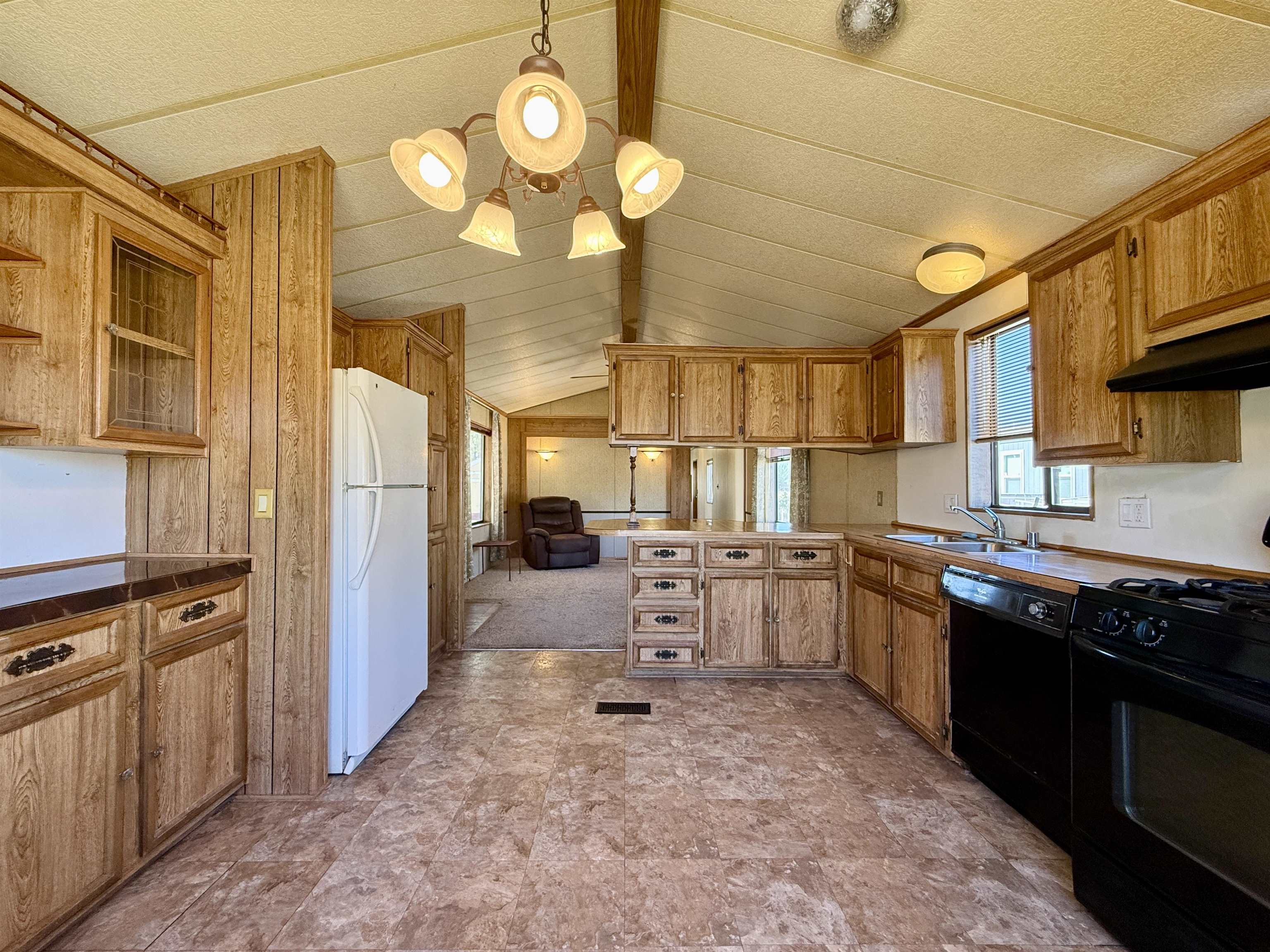 3251 E Road, Unit 33 Clifton, CO 81520 - Photo 9 of 28 a kitchen with stainless steel appliances a stove a sink dishwasher and cabinets with wooden floor