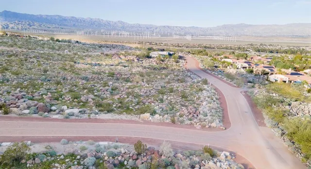 a view of a dry yard with wooden fence
