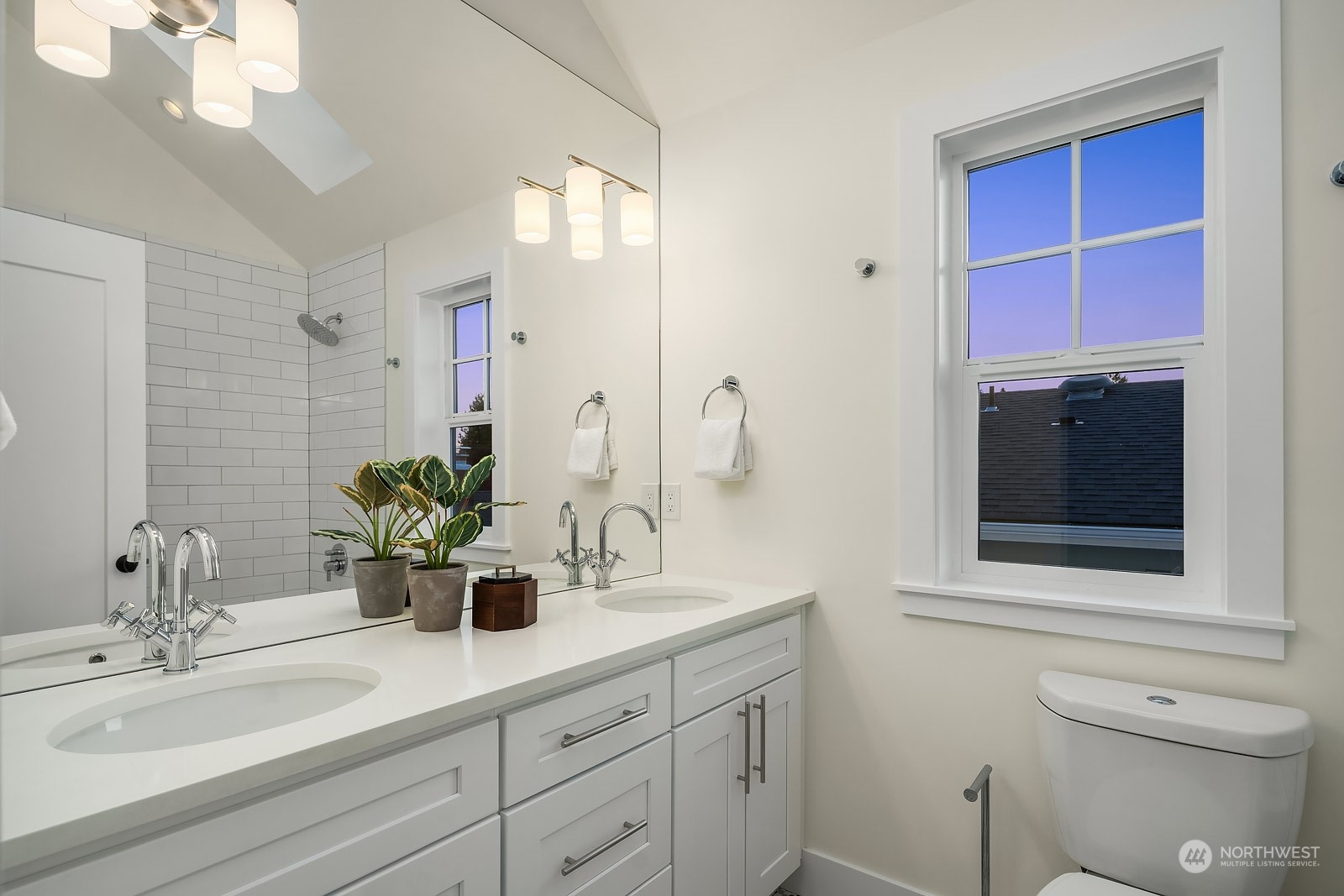 706 North 76th Street Seattle, WA 98103 - Photo 26 of 38 a bathroom with a toilet a sink and mirror