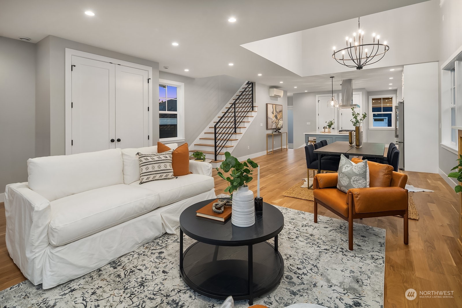 706 North 76th Street Seattle, WA 98103 - Photo 7 of 38 a living room with furniture and a chandelier