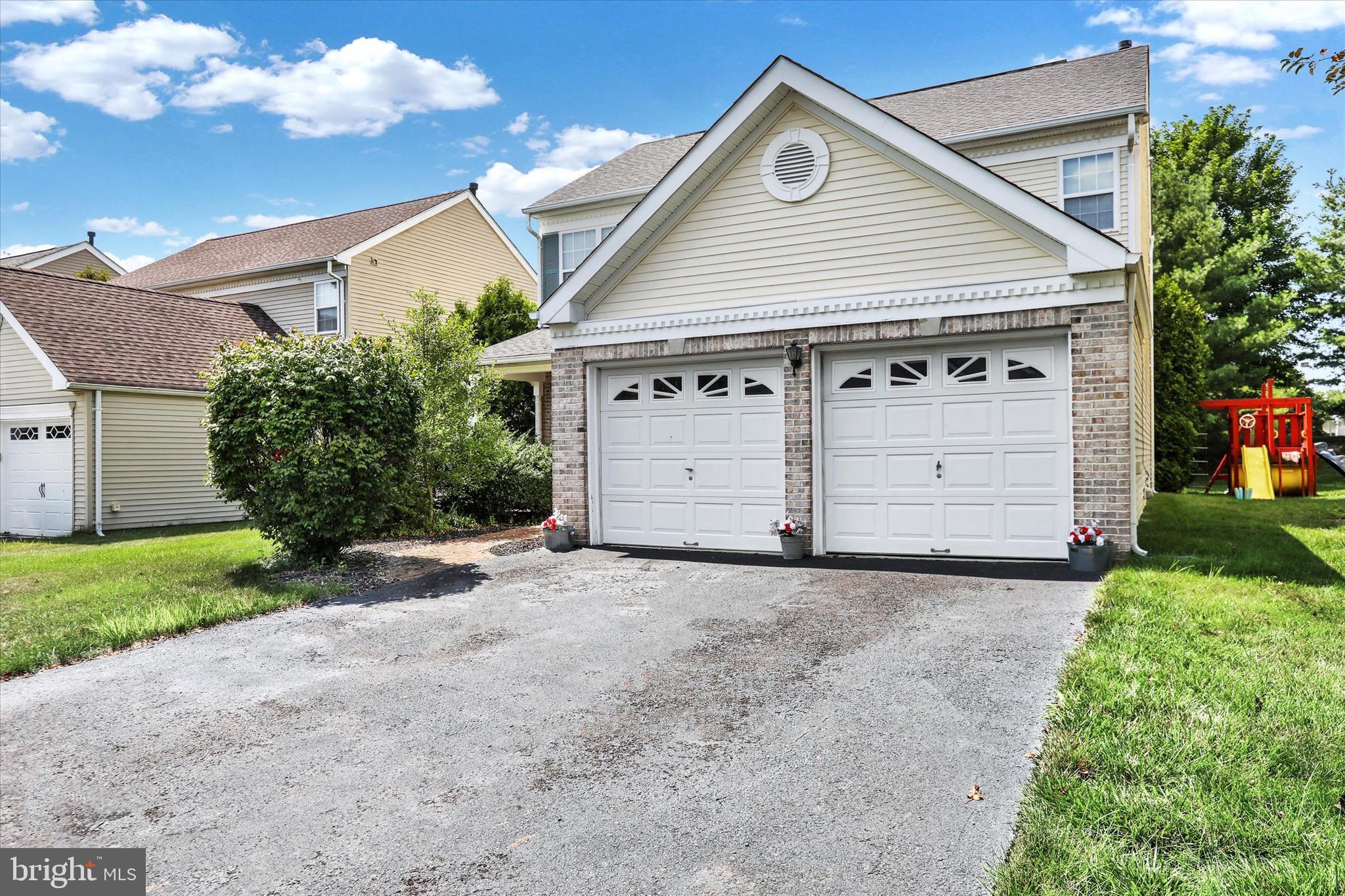 5 Brownstone Road Hightstown, NJ 08520 - Photo 4 of 21 a front view of a house with a yard and garage