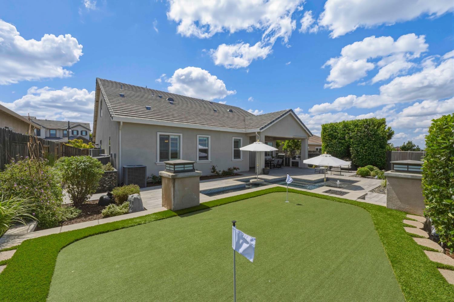 2259 Ranch View Drive Rocklin, CA 95765 - Photo 38 of 54 rear view of house with a patio area, stucco siding, a fenced backyard, and a putting area