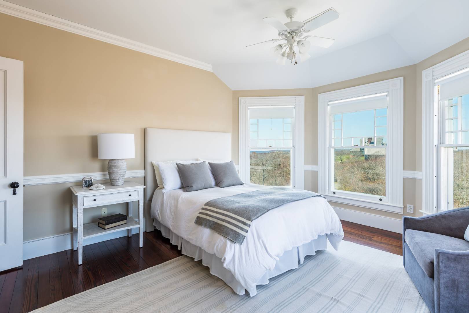 176 Deforest Road Montauk, NY 11954 - Photo 18 of 37 a spacious bedroom with a bed and a chandelier
