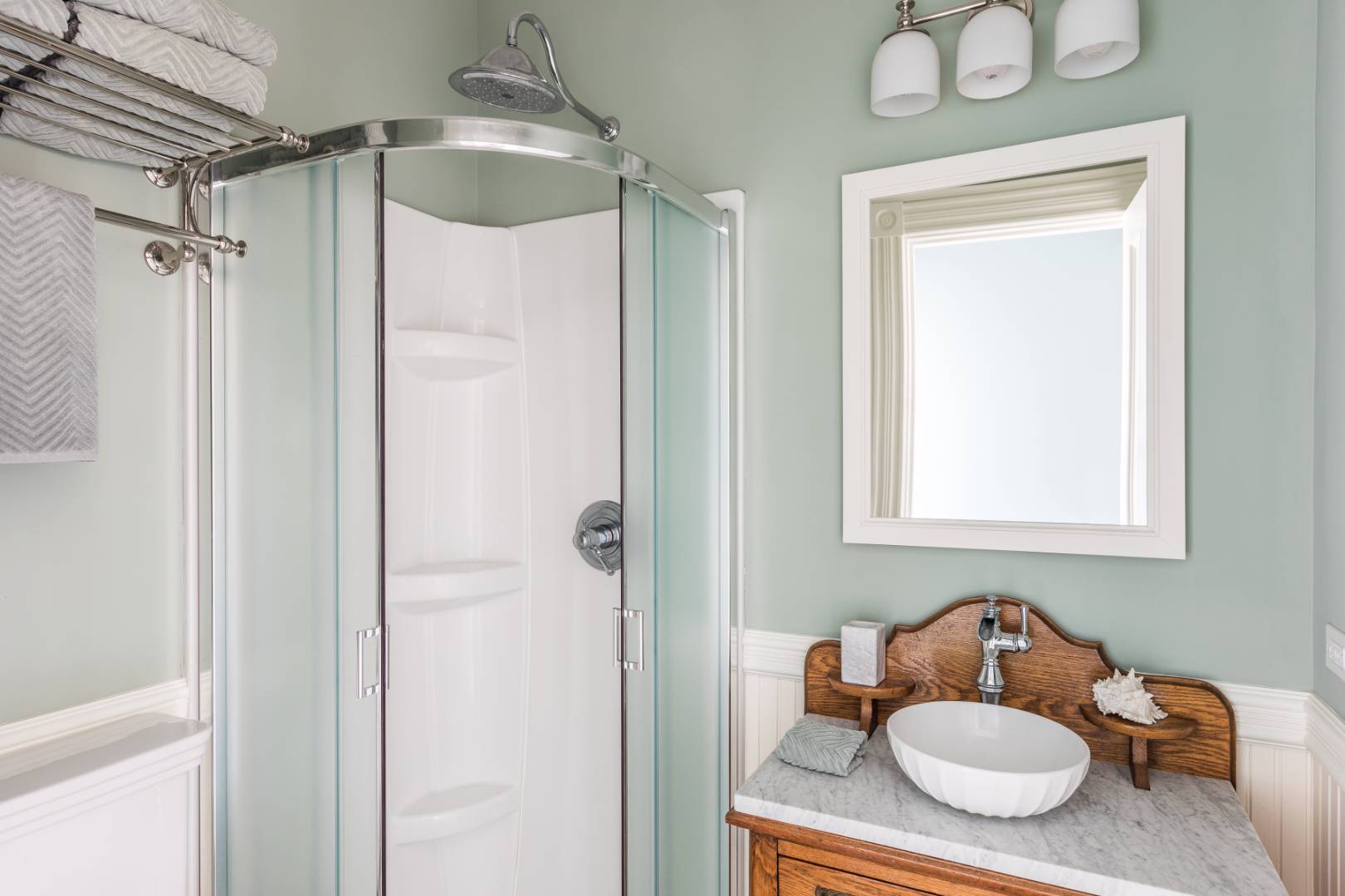176 Deforest Road Montauk, NY 11954 - Photo 21 of 37 a bathroom with a sink vanity mirror and shower