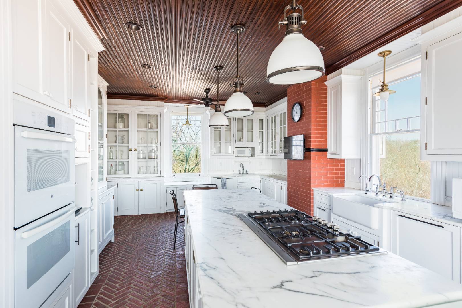176 Deforest Road Montauk, NY 11954 - Photo 7 of 37 a kitchen with stainless steel appliances granite countertop a stove a sink dishwasher and white cabinets with wooden floor