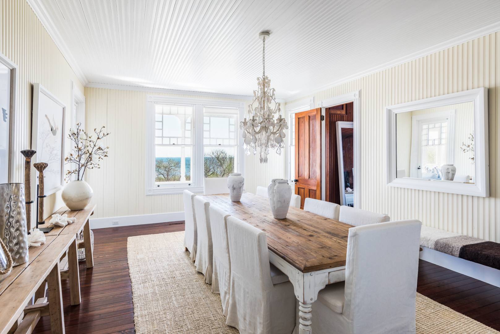 176 Deforest Road Montauk, NY 11954 - Photo 9 of 37 a living room with furniture and a chandelier