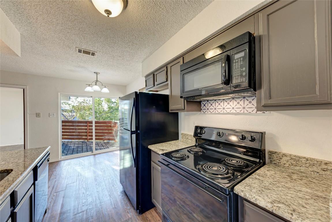 2106 Nickerson Street, Unit 203 Austin, TX 78704 - Photo 13 of 38 a kitchen with a stove microwave and refrigerator
