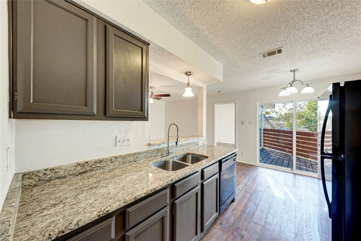 2106 Nickerson Street, Unit 203 Austin, TX 78704 - Photo 14 of 38 a kitchen with granite countertop a sink and a stove