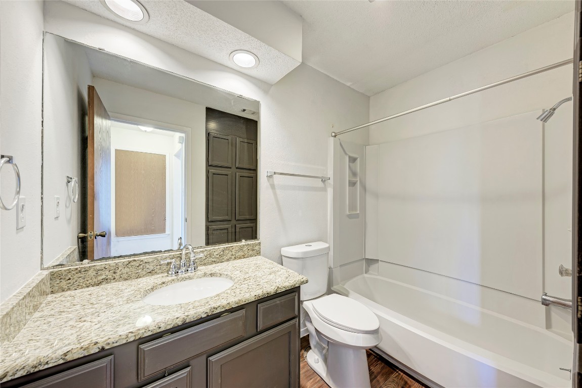 2106 Nickerson Street, Unit 203 Austin, TX 78704 - Photo 23 of 38 a bathroom with a granite countertop sink toilet and shower