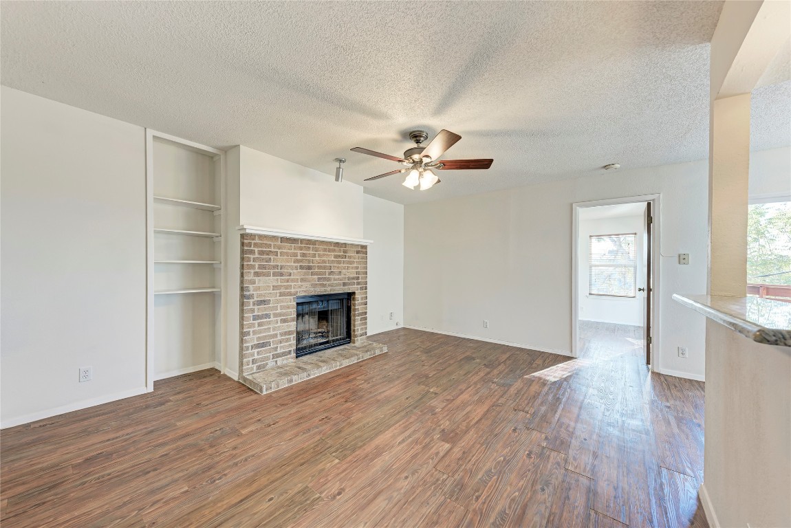 2106 Nickerson Street, Unit 203 Austin, TX 78704 - Photo 3 of 38 an empty room with wooden floor fireplace and windows