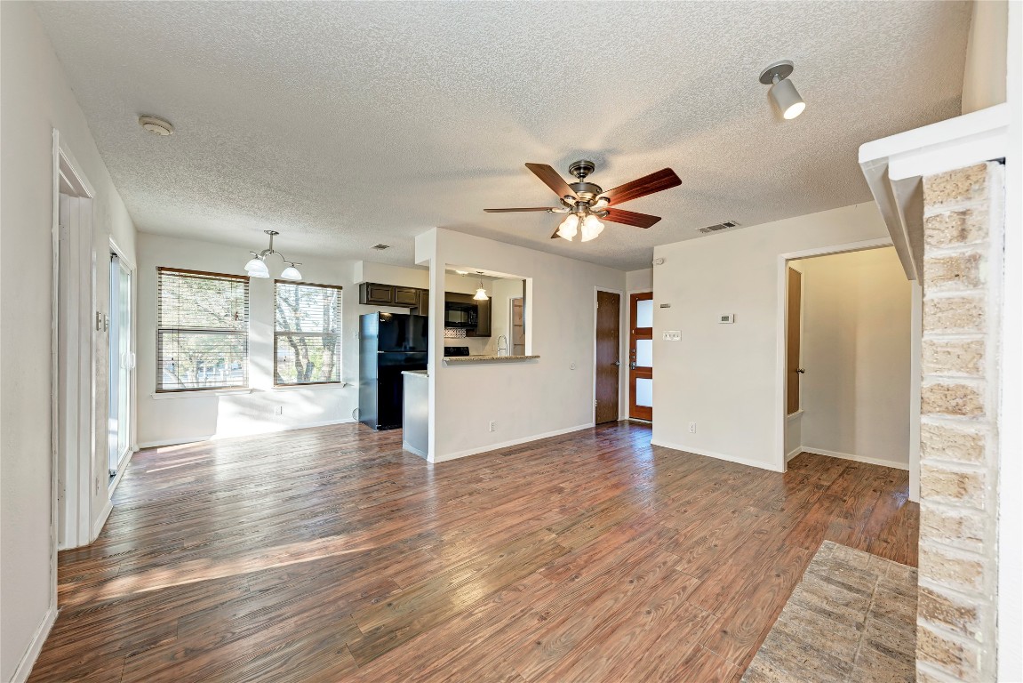 2106 Nickerson Street, Unit 203 Austin, TX 78704 - Photo 5 of 38 a view of an empty room with window and wooden floor