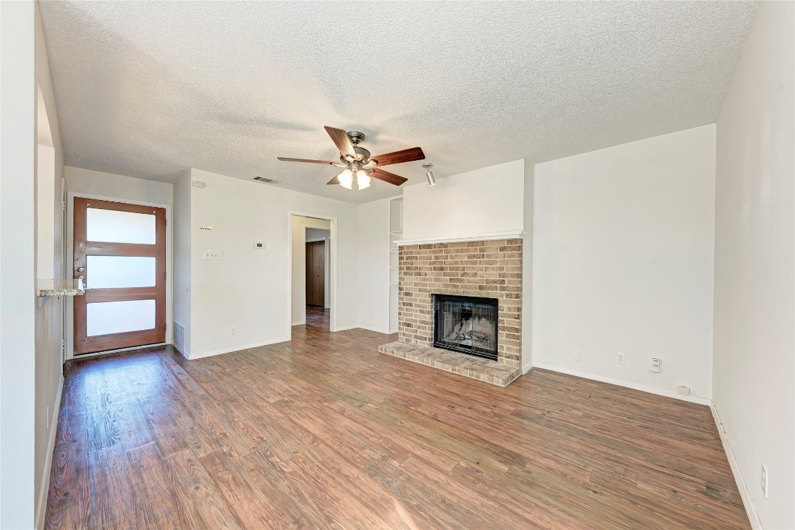 2106 Nickerson Street, Unit 203 Austin, TX 78704 - Photo 6 of 38 wooden floor in an empty room with a fireplace