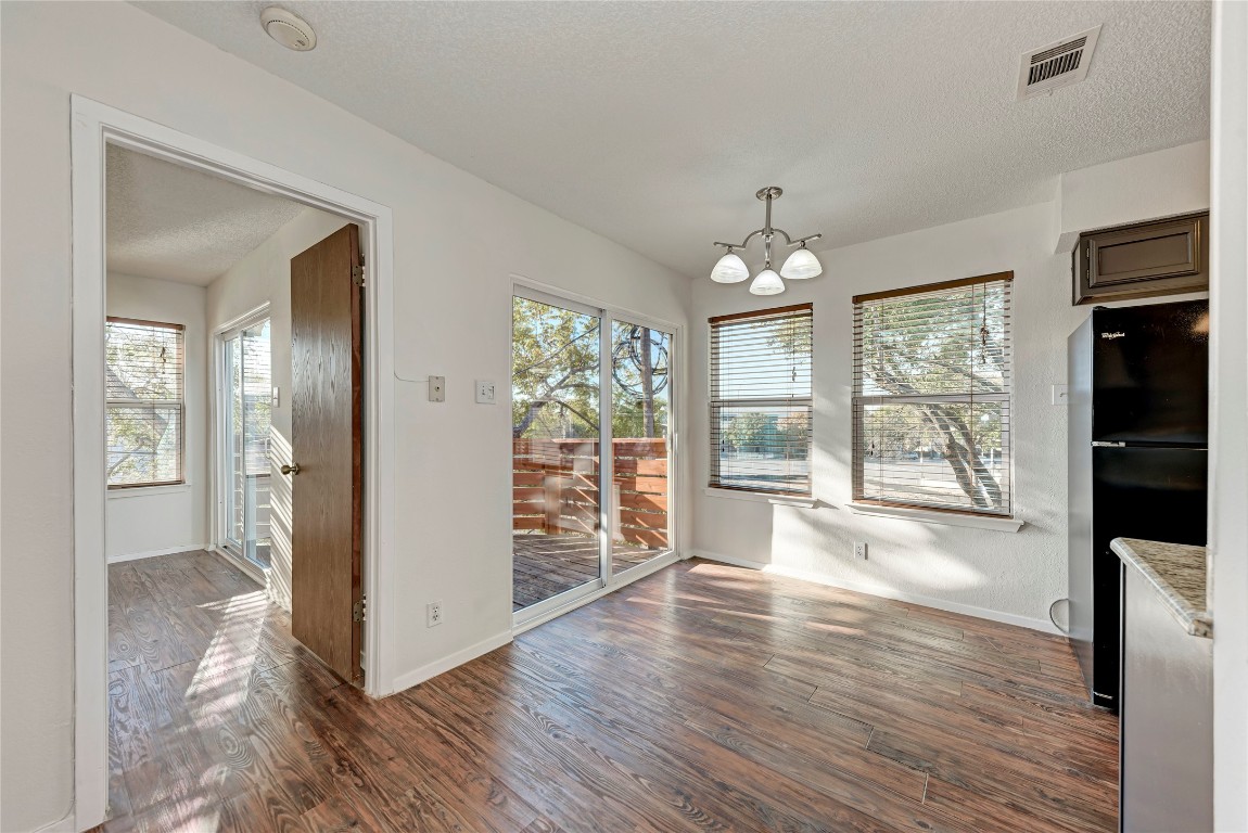 2106 Nickerson Street, Unit 203 Austin, TX 78704 - Photo 8 of 38 wooden floor in an empty room with a window