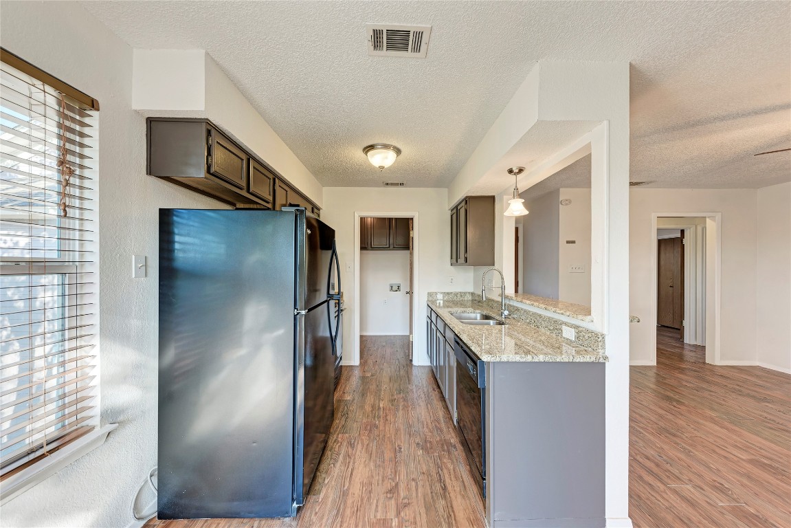 2106 Nickerson Street, Unit 203 Austin, TX 78704 - Photo 10 of 38 a kitchen with stainless steel appliances granite countertop a refrigerator a sink and a stove