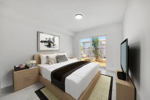 a bedroom with a bed and a large mirror