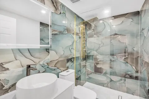 a bathroom with a sink toilet and shower