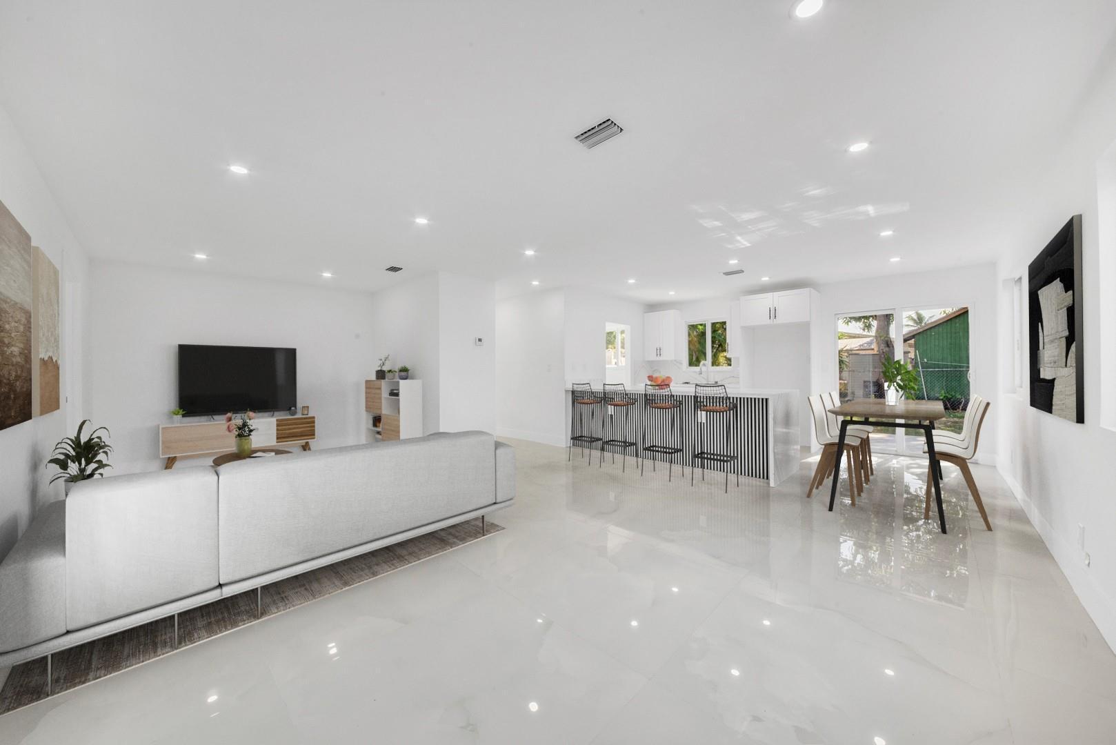 120 Northeast 57th Court Oakland Park, FL 33334 - Photo 2 of 20 a living room with furniture and a flat screen tv