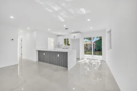 a view of a kitchen with a sink and a window