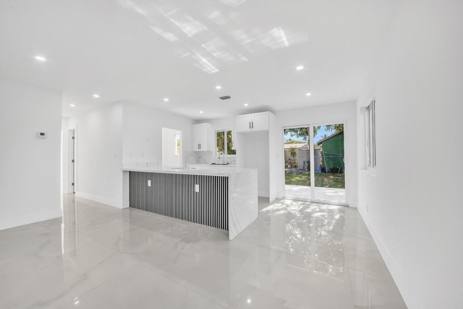 120 Northeast 57th Court Oakland Park, FL 33334 - Photo 5 of 20 a view of a kitchen with a sink and a window