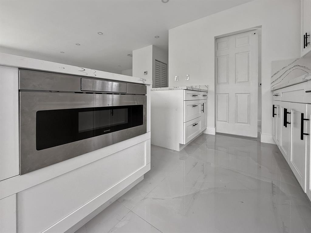 120 Northeast 57th Court Oakland Park, FL 33334 - Photo 6 of 20 a utility room with washer and dryer
